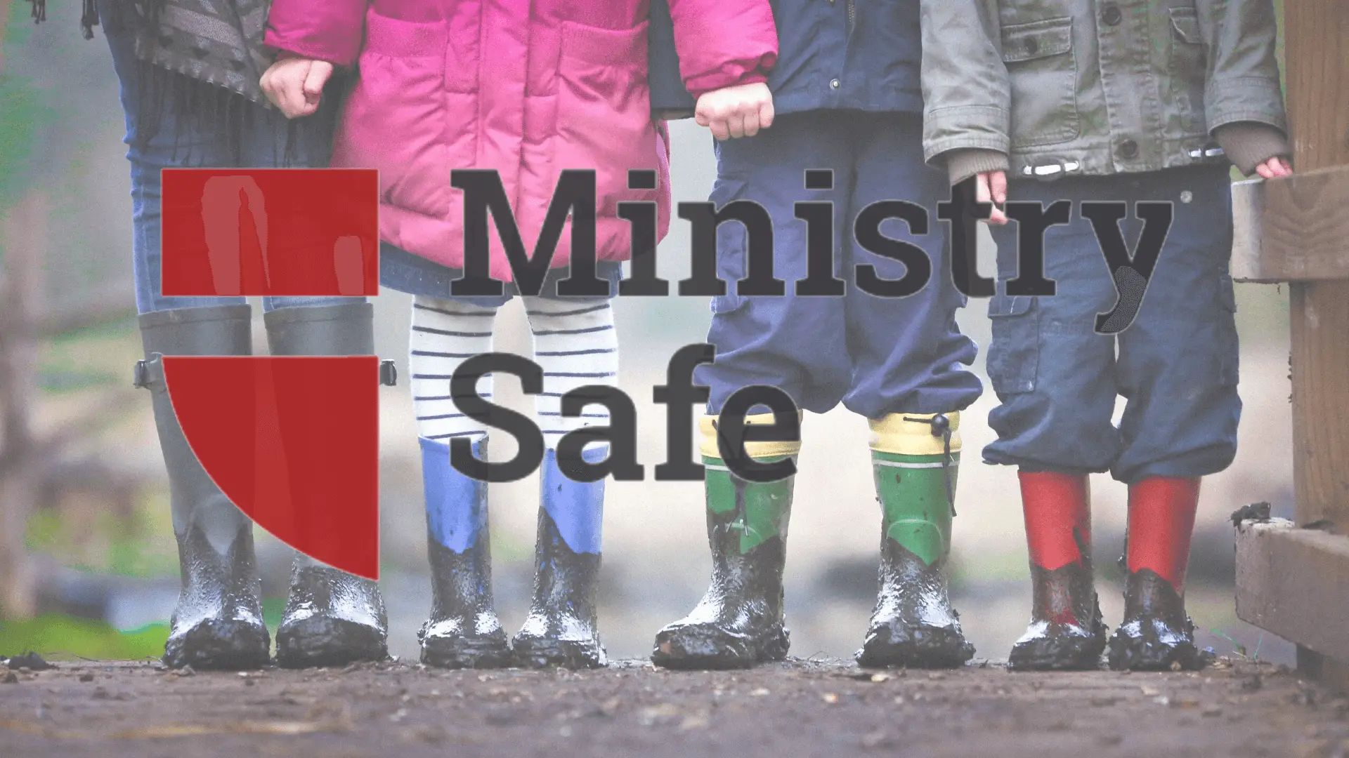 Children in rain boots holding hands with Ministry Safe Logo overlayed